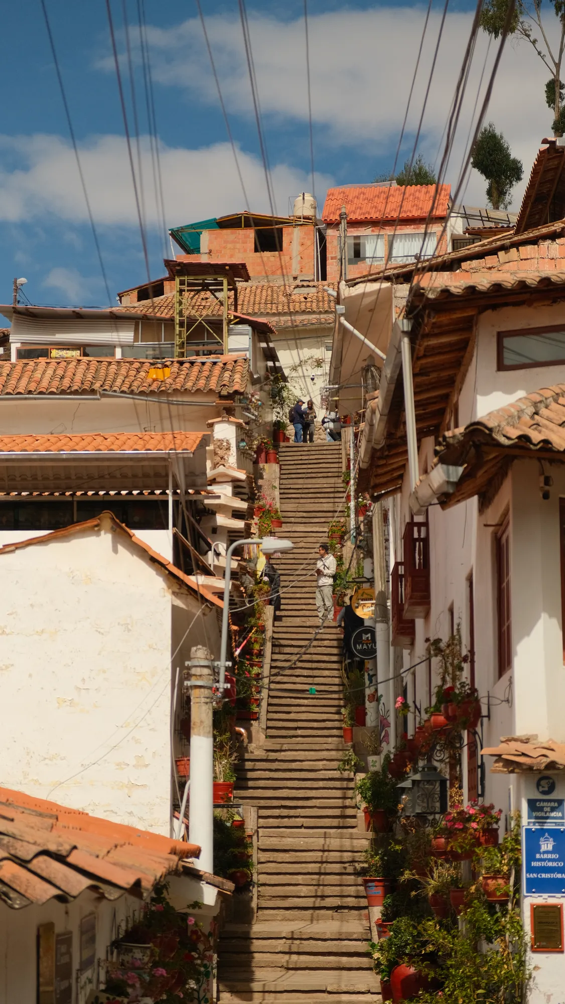 Cusco's hillside neighborhoods and terracotta rooftops seen from an overlook above the city.