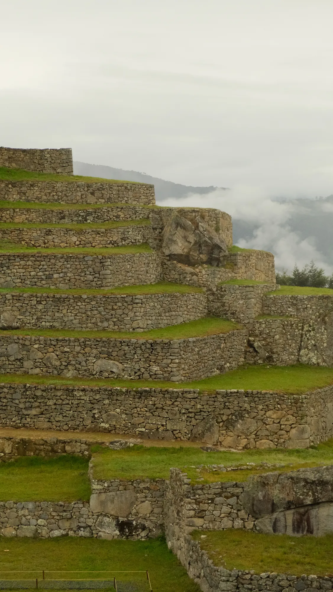 Low cloud clings to the mountainside near Machu Picchu in the early morning light.