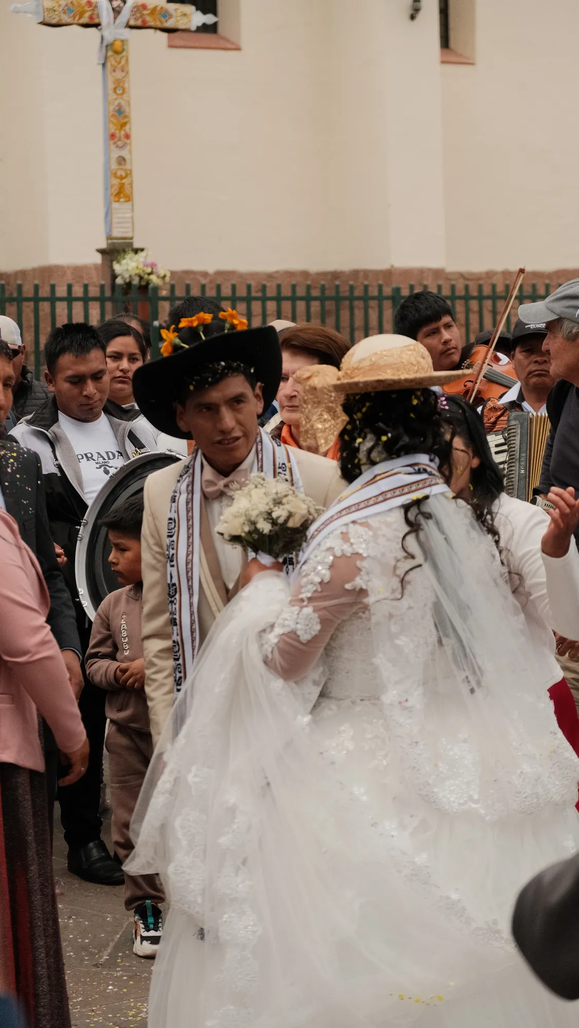 Musicians with a violin, accordion, and drum play beside the wedding party in Pisac.