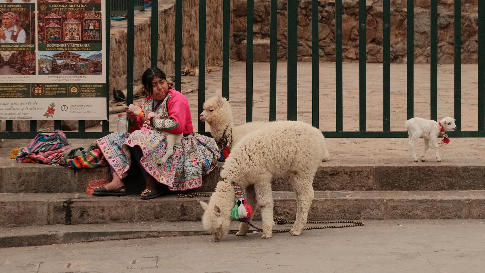 A close view of the wedding party in Pisac's plaza, woven Andean sashes over formal dress.