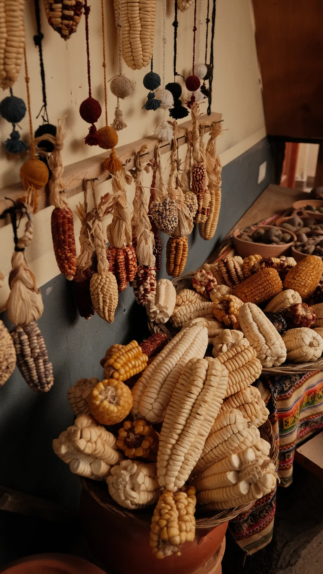 Dried native corn in dozens of colors hangs and piles up at a highland farm stop, alongside baskets of native potatoes and hand-spun wool tassels.