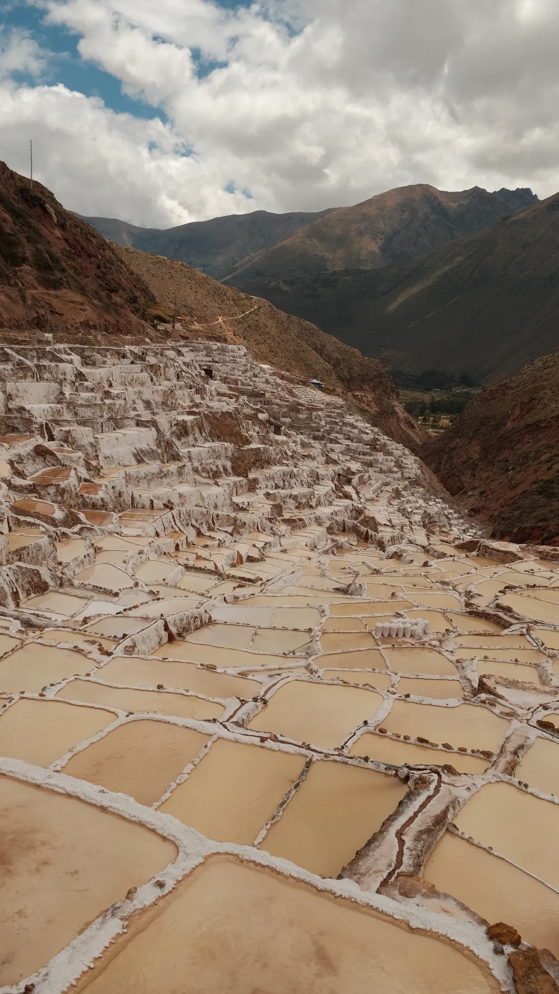 Thousands of small salt pans step down the hillside at Maras, worked since Inca times, fed by a natural spring.